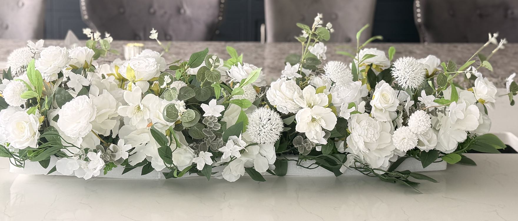 A three-metre ivory and eucalyptus top table run